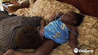 A white guy has sex with a black midget, showcasing interracial passion