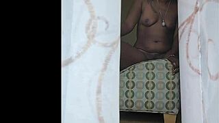 Naejae Onyxx, a tall black woman, pleasures herself through the window